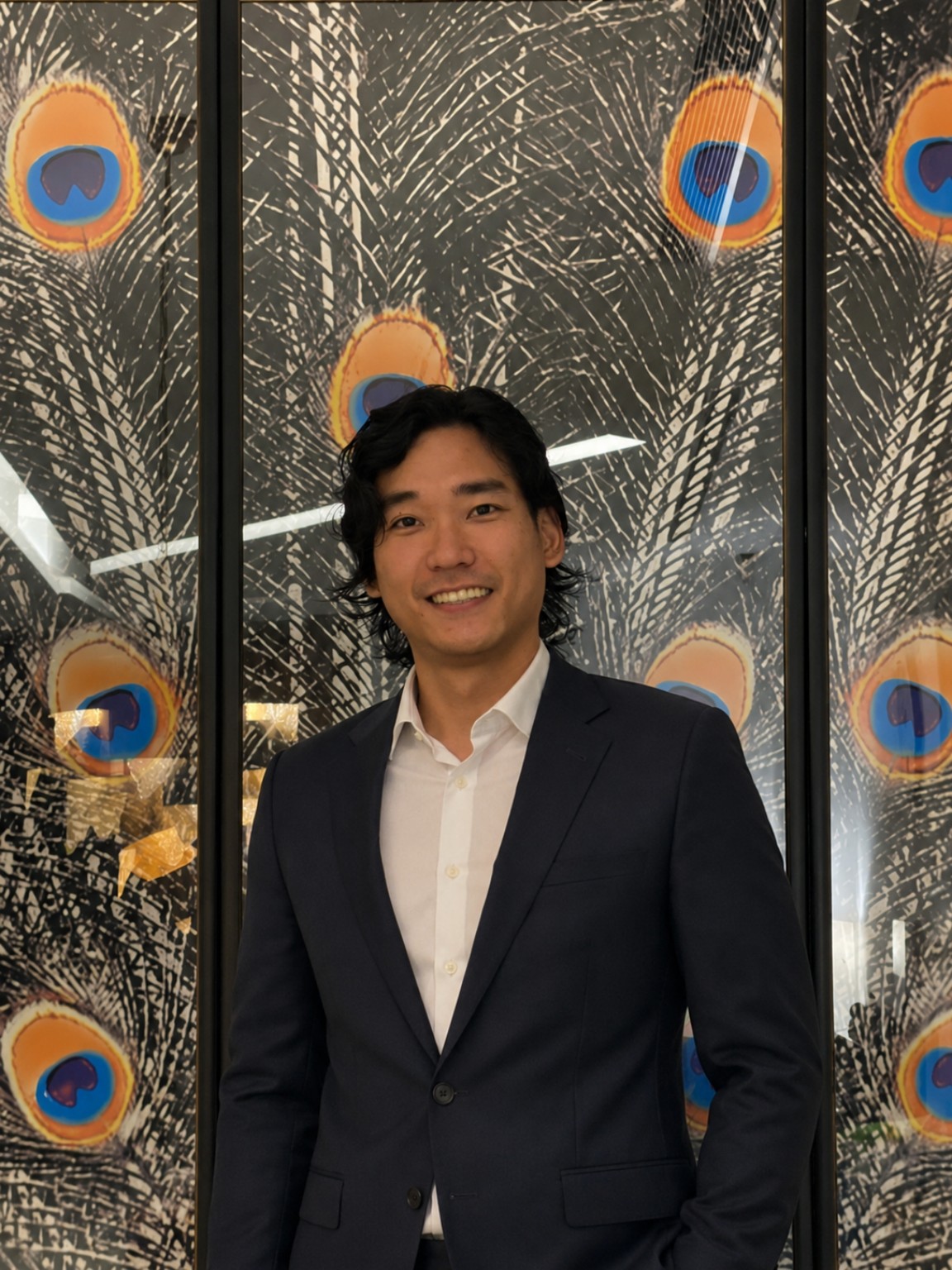 Jasper Kwong in a navy suit and white shirt